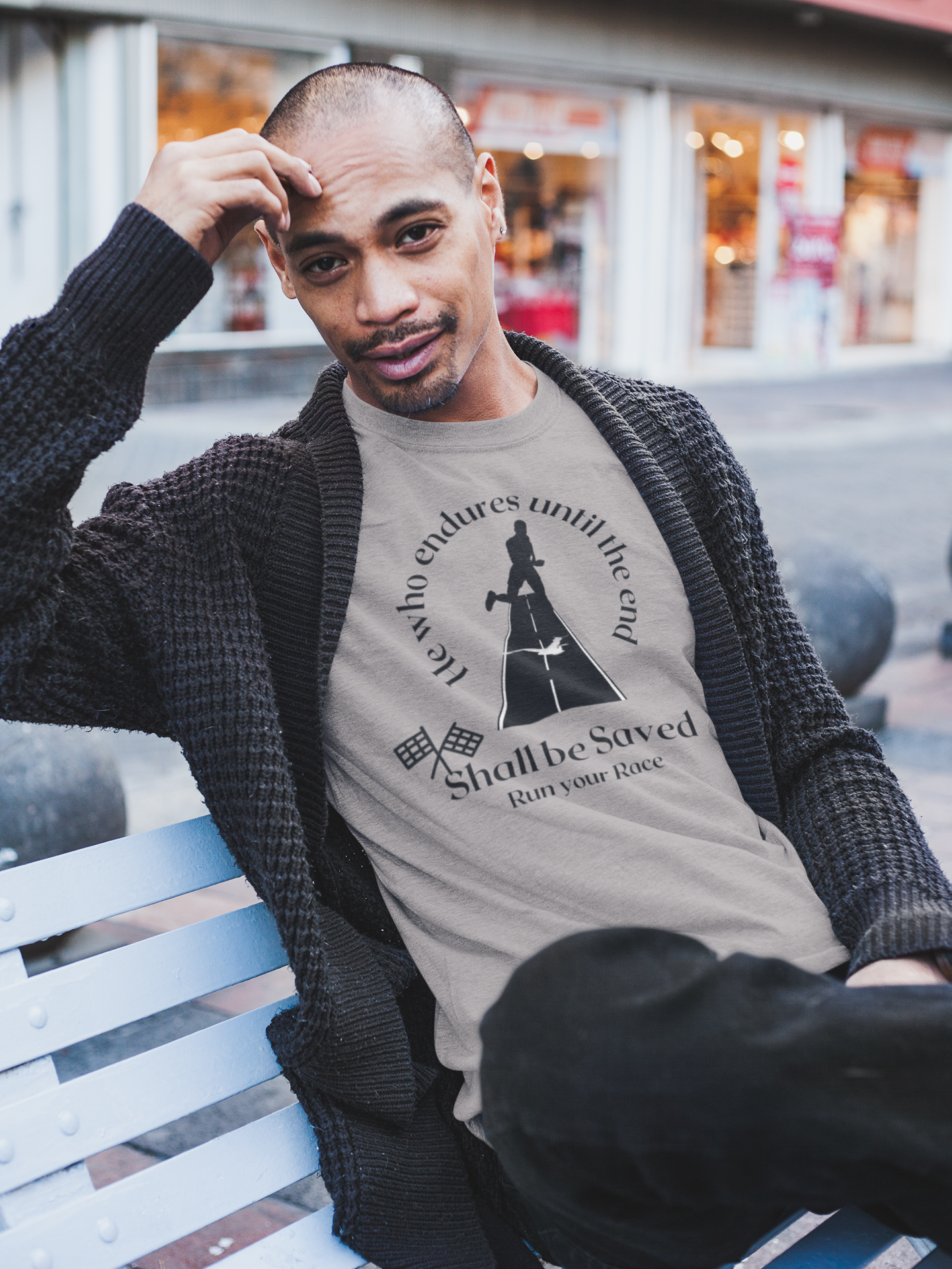 man sitting on bench wearing tee with man running and with race flags and reads  "He who endures until the End shall be saved tshirt, Christian end times tee gift, Religious t-shirt, Revelations tshirt, Jesus tee, faith graphic tee.***See Matching Notebook. available in many colors, unisex