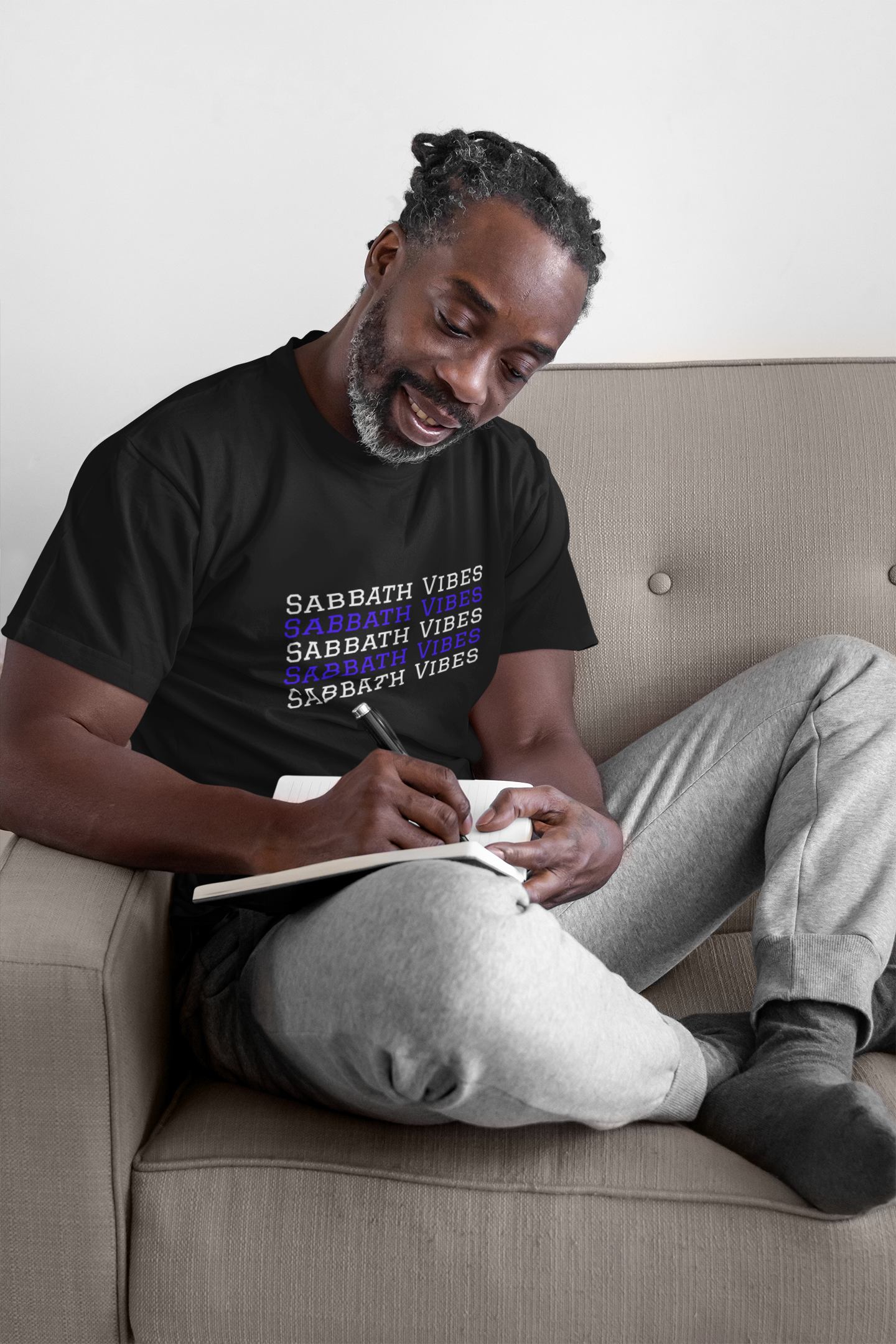 smiling man sitting on couch writing in journal and wearing tshirt that reads-Sabbath Vibes- Sabbath Keepers tee, 4th Commandment gift, Hebrew clothing, Israelite tee, Christian motivational tshirt, day of rest t-shirt, family tee, ***See Matching Mug, Tote, Notebook , available in many colors