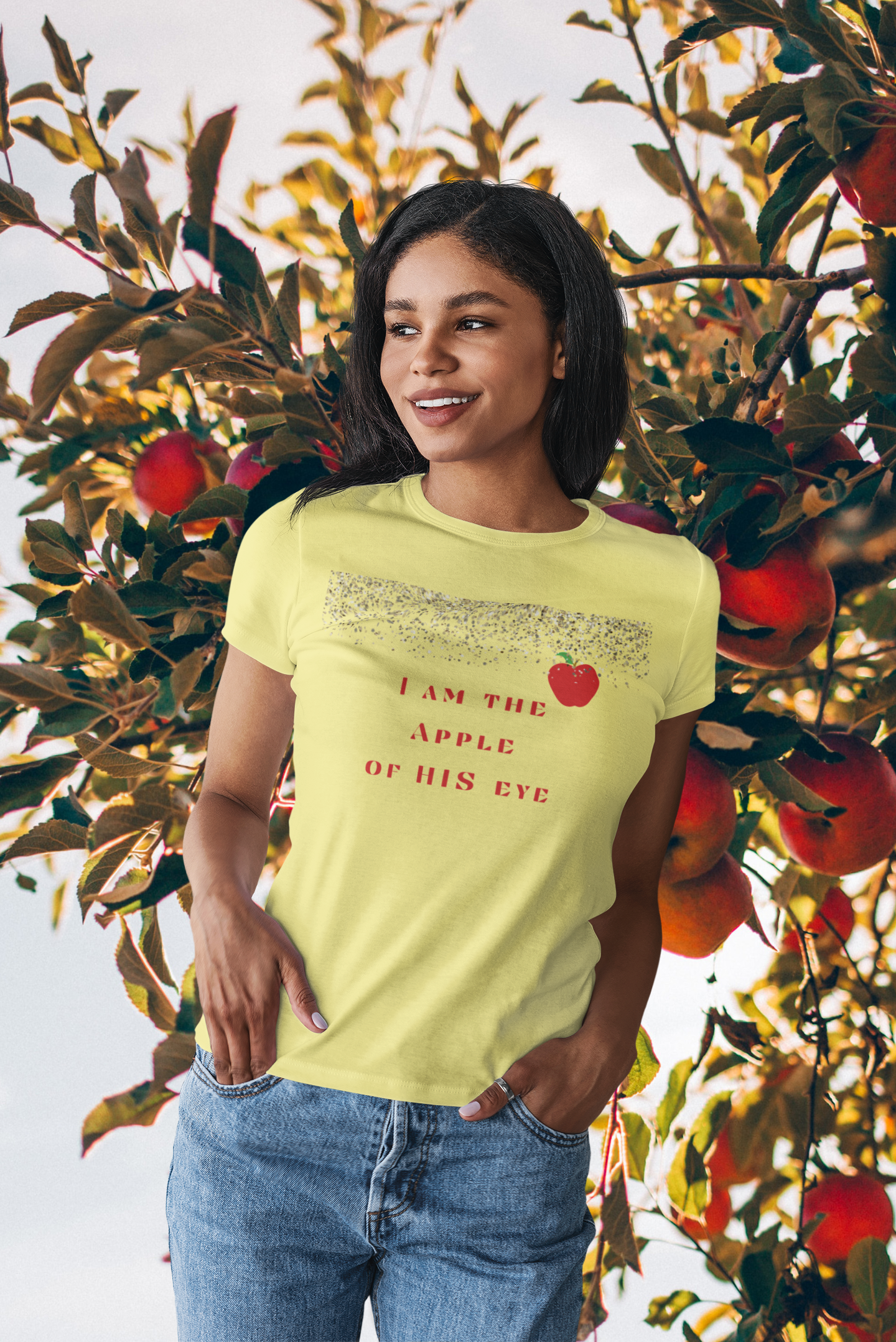 woman standing near apple tree with tee with  glittery stars  and an apple, and reads "I am the apple of HIS eye Christian t-shirt, Faith tshirt, Inspirational gift for religious women, Jesus tee, Inspirational tee, apple tee ,  many colors available